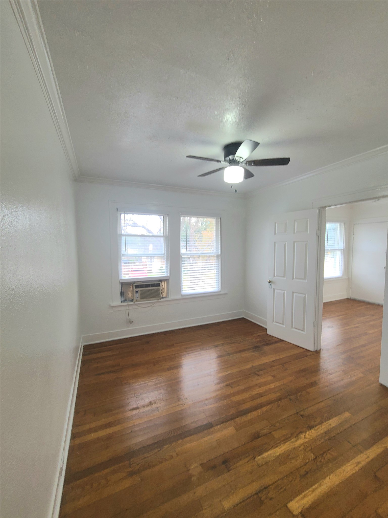 4414 Woodside Street, Unit 8 Houston, TX 77023 - Photo 10 of 14 a view of an empty room with wooden floor and a window