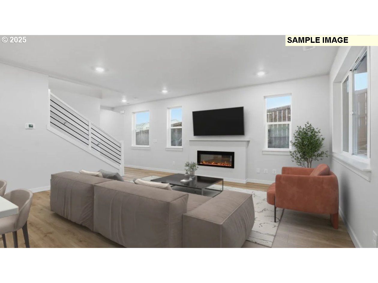 3739 Southwest 40th Street Gresham, OR 97080 - Photo 6 of 11 a living room with furniture a fireplace and a flat screen tv