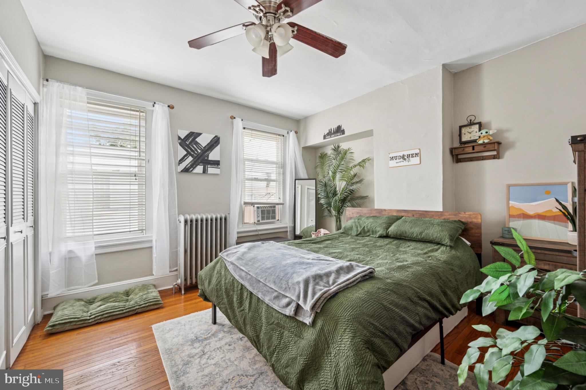 142 Davis Street Philadelphia, PA 19127 - Photo 12 of 17 a bedroom with a large bed chandelier and a window
