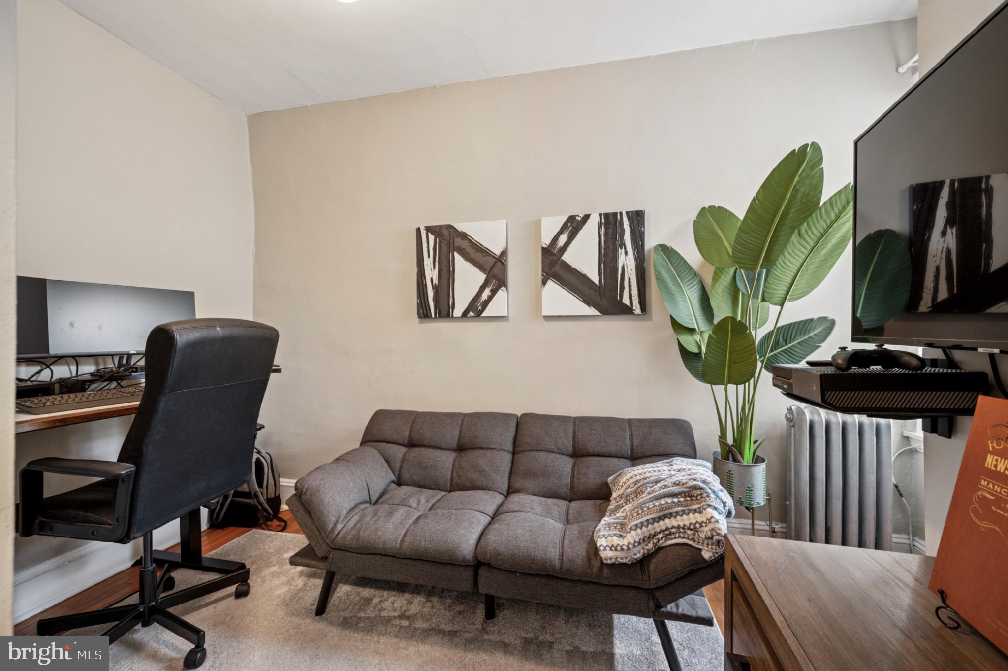 142 Davis Street Philadelphia, PA 19127 - Photo 14 of 17 a living room with furniture a piano and a flat screen tv