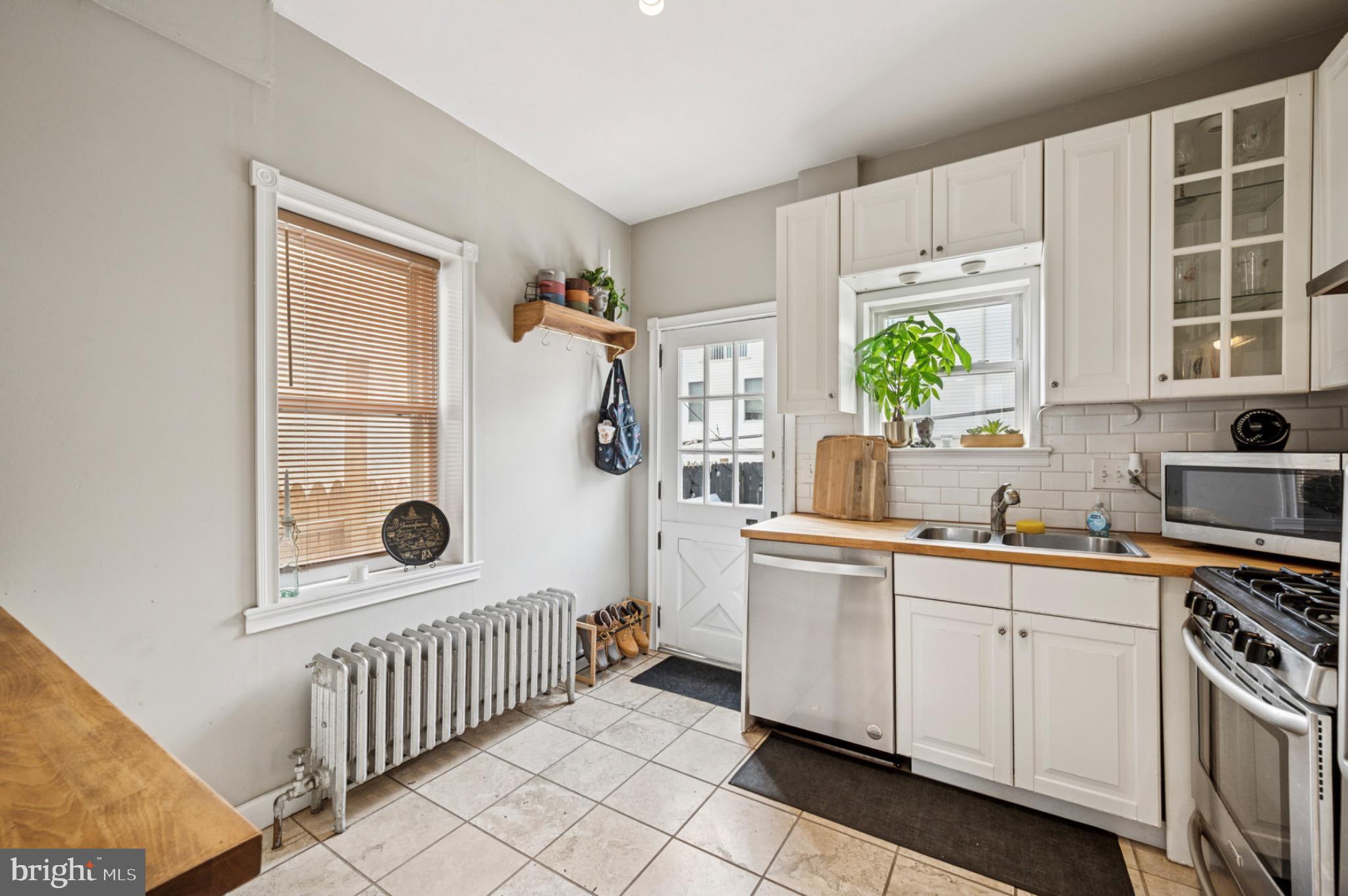 142 Davis Street Philadelphia, PA 19127 - Photo 8 of 17 a kitchen with white cabinets and window