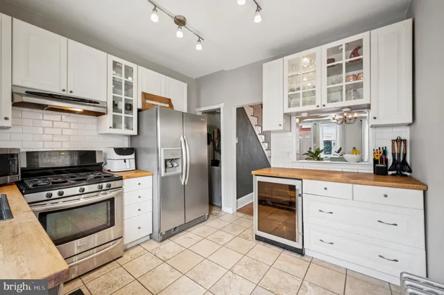 a kitchen with stainless steel appliances a stove a sink and a refrigerator