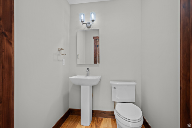 4221 Juniper Circle Alpine, UT 84004 - Photo 21 of 66 Pedestal sink with a single-handle faucet, rectangular mirror, and an overhead vanity light fixture