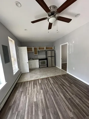 a view of empty room with wooden floor