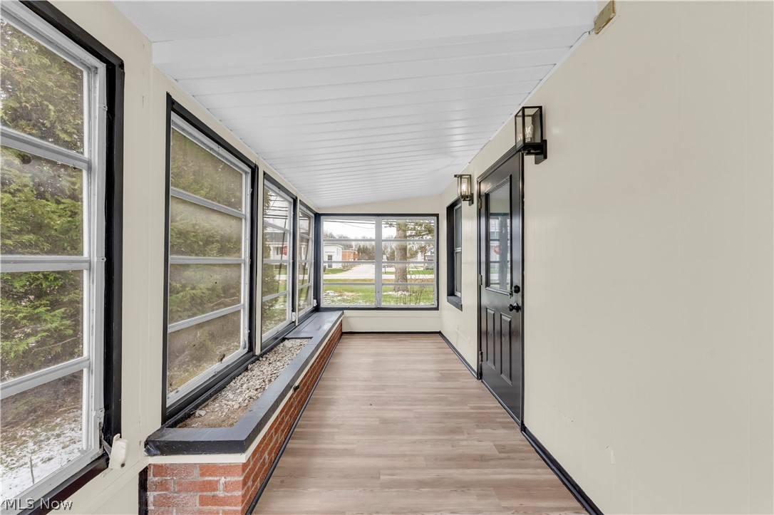 7320 Avon Belden Road North Ridgeville, OH 44039 - Photo 8 of 33 Unfurnished sunroom with wood finished floors and vaulted ceiling
