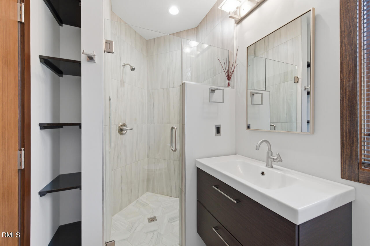 3315 Denada Path Durham, NC 27707 - Photo 39 of 74 a bathroom with a sink mirror and shower