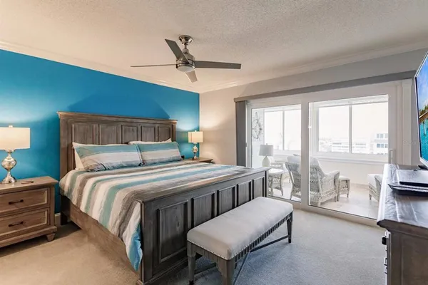 a bedroom with a bed a table and chairs