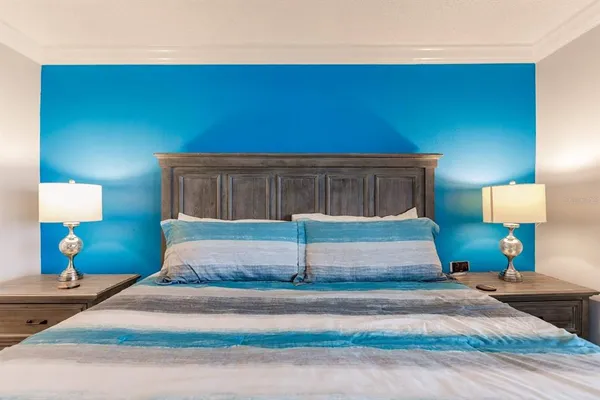 a bedroom with a bed and a lamp