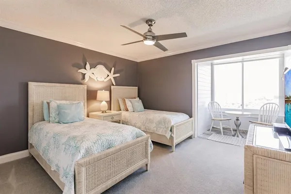 a bedroom with two beds and a large window