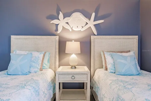 a bedroom with a bed and a lamp