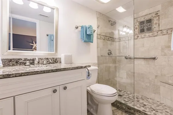 a bathroom with a sink toilet and shower