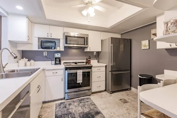 a kitchen with a sink appliances and cabinets