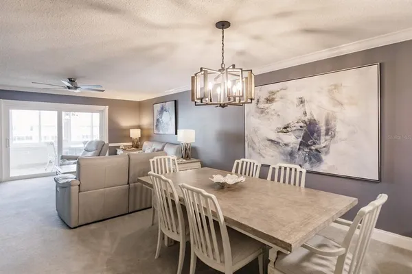 a view of a dining room with furniture wooden floor and chandelier