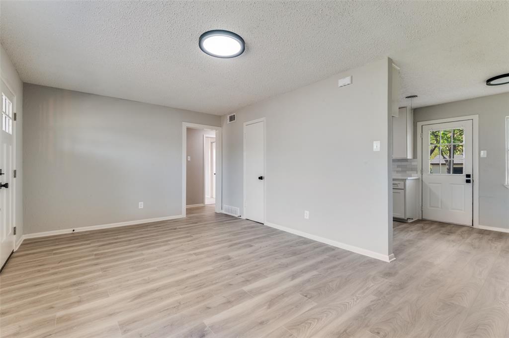 2320 Muret Street Irving, TX 75062 - Photo 3 of 12 an empty room with windows and closet