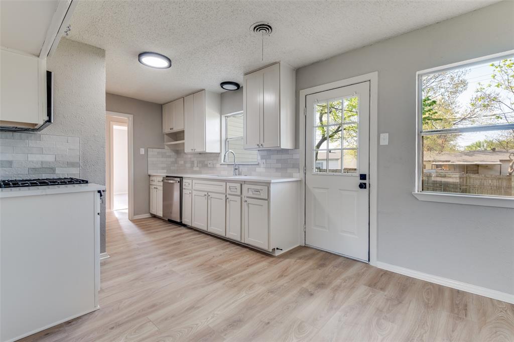 2320 Muret Street Irving, TX 75062 - Photo 4 of 12 a kitchen with stainless steel appliances granite countertop a stove and a refrigerator