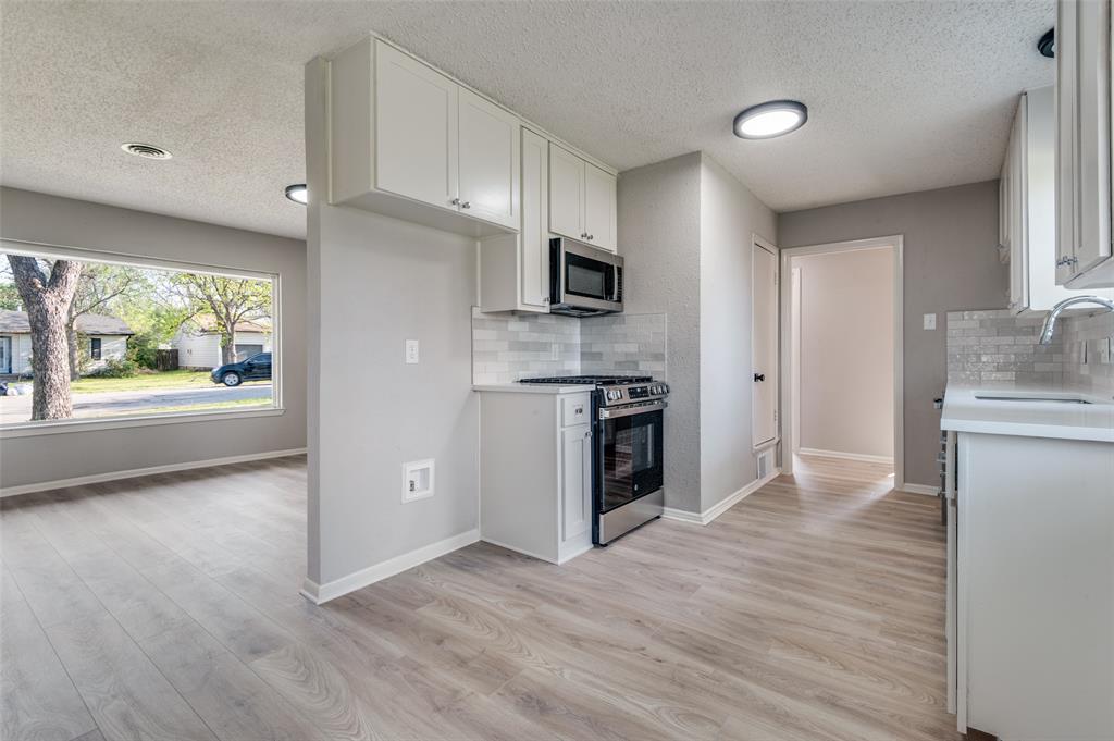 2320 Muret Street Irving, TX 75062 - Photo 5 of 12 a kitchen with stainless steel appliances granite countertop a refrigerator sink and stove