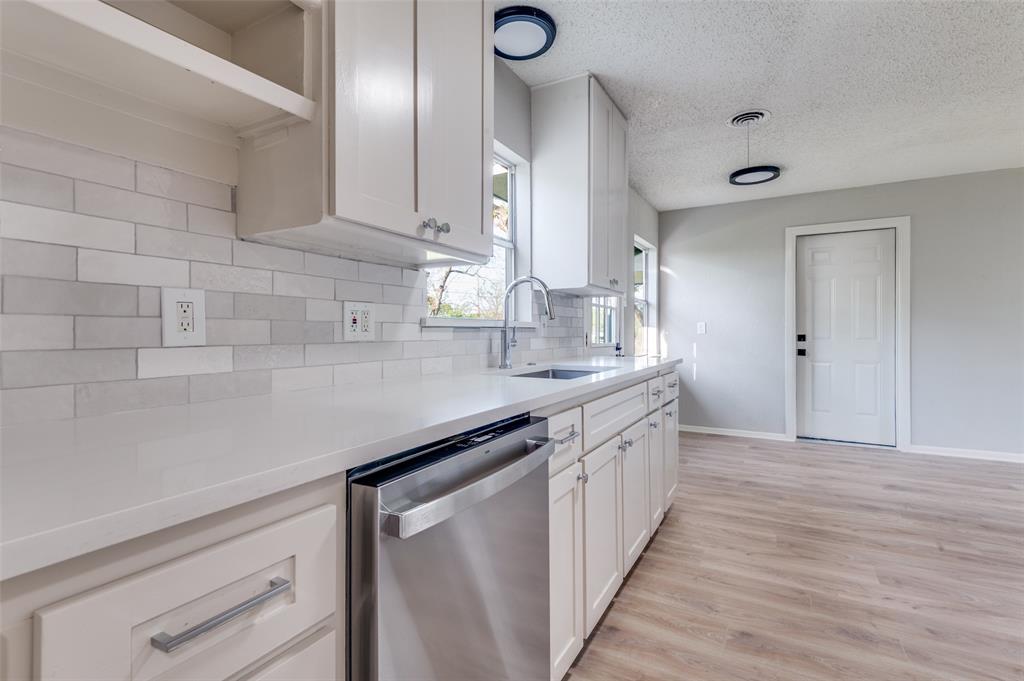 2320 Muret Street Irving, TX 75062 - Photo 6 of 12 a kitchen with granite countertop a sink and cabinets