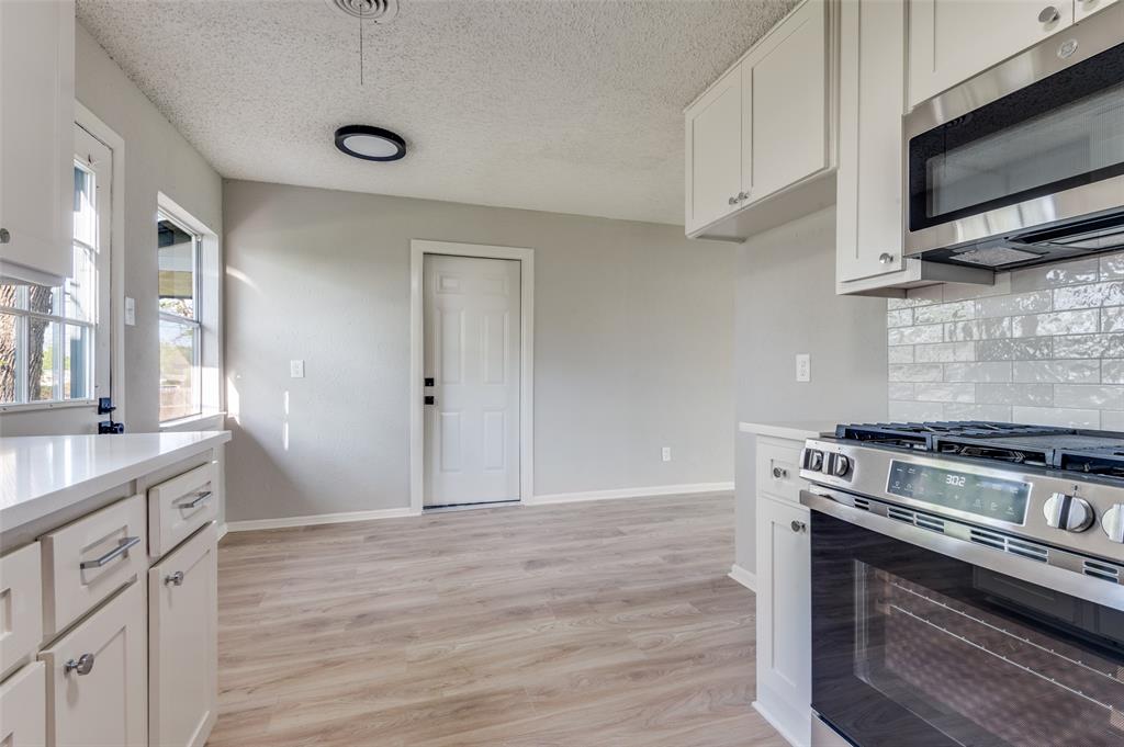 2320 Muret Street Irving, TX 75062 - Photo 7 of 12 a kitchen with a stove and a microwave