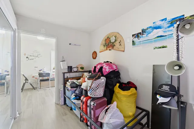 a bedroom with two bed and a painting on the wall