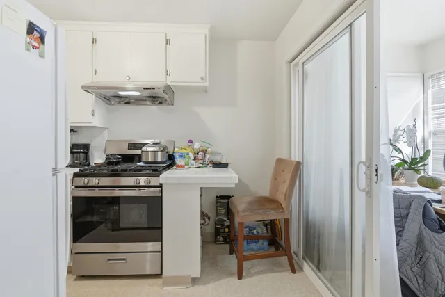 a kitchen with a refrigerator and a sink