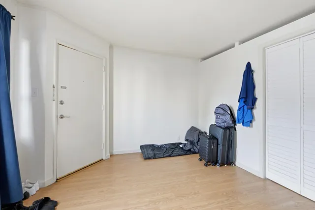 a bedroom with furniture and a flat screen tv