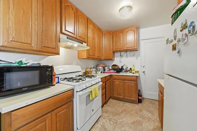 a kitchen with a refrigerator and a stove