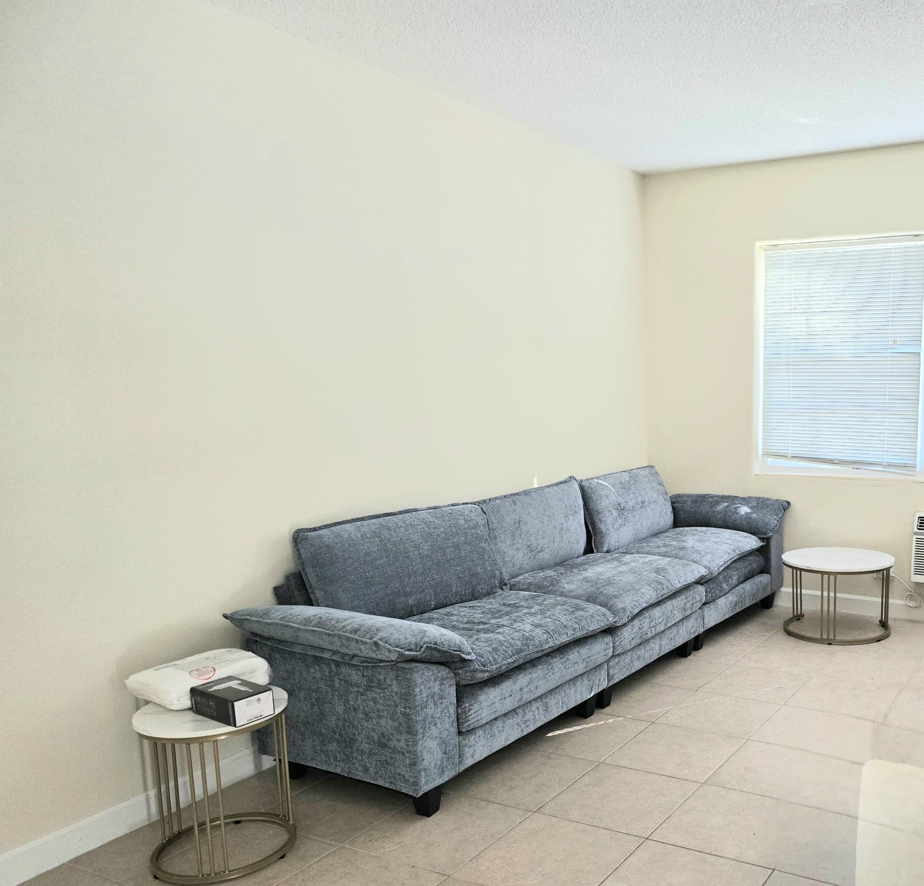 224 Conniston Road, Unit 3 West Palm Beach, FL 33405 - Photo 3 of 12 a living room with a couch and a potted plant