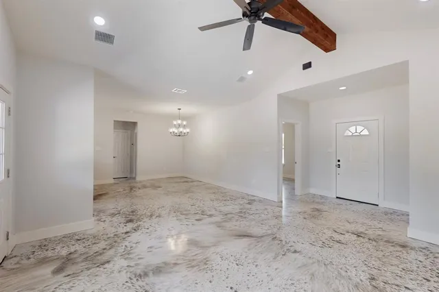 a view of a livingroom with a ceiling fan and window