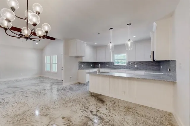 a view of a kitchen with a sink and cabinets