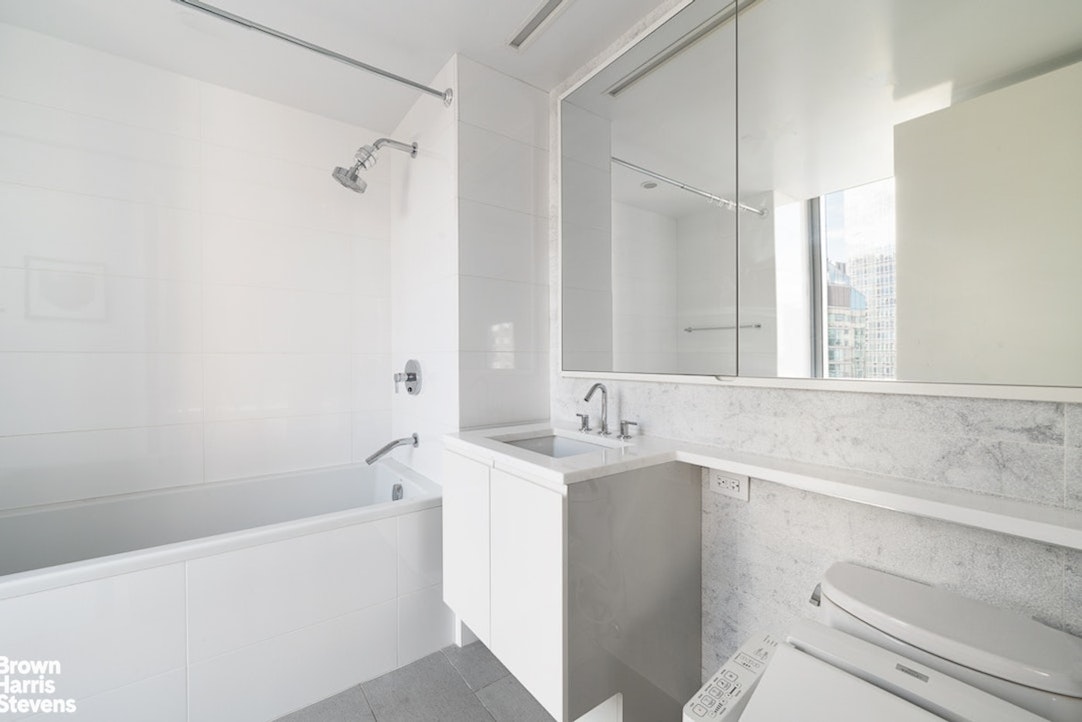 50 Riverside Boulevard, Unit 21A Manhattan, NY 10069 - Photo 10 of 11 a bathroom with a sink a toilet and shower
