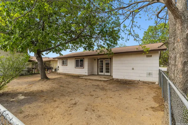 a view of a house with a tree in the background