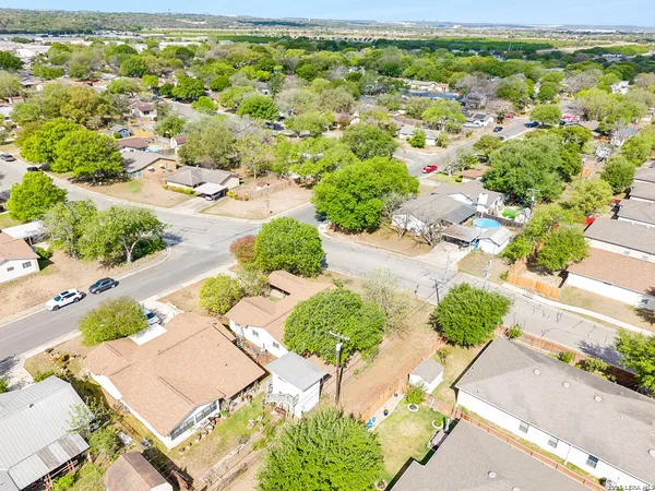 an aerial view of residential houses with outdoor space