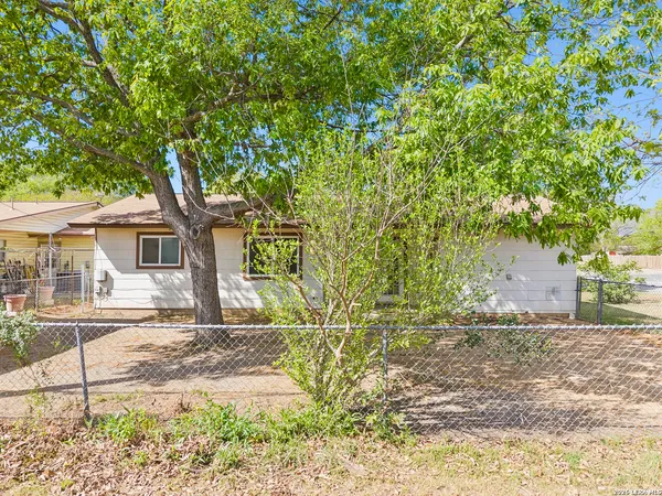 a house that has a tree in front of it