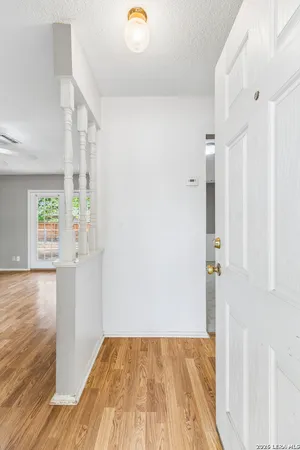 a view of a room with wooden floor and windows