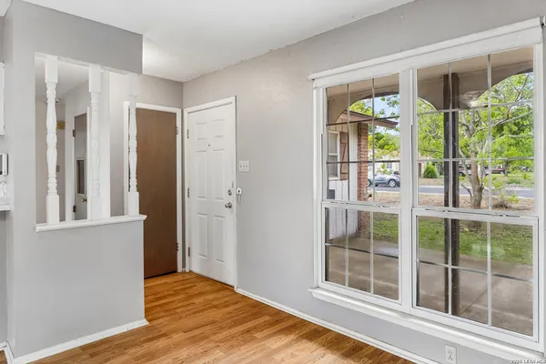 a view of wooden floor and windows in a room
