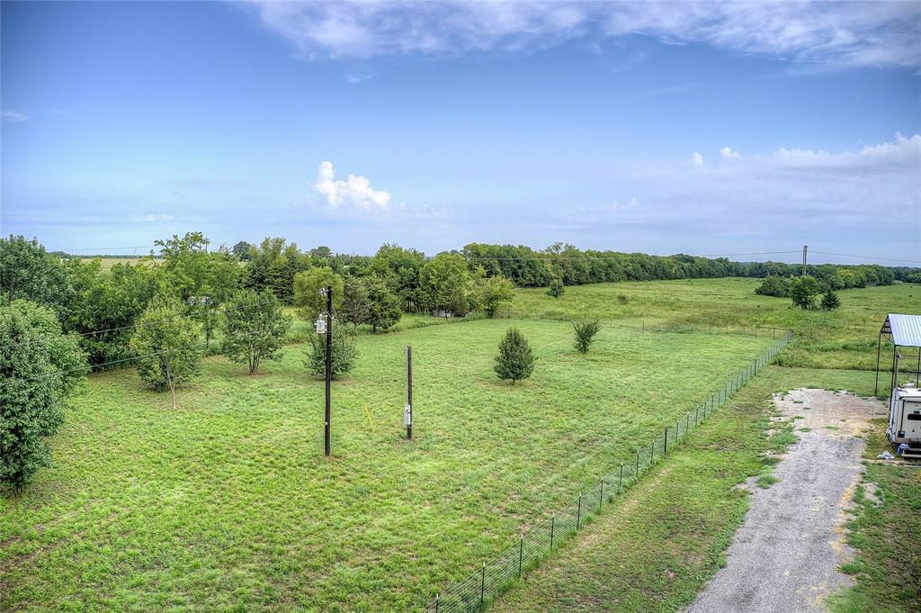 868 County Road 23940 Brookston, TX 75421 - Photo 29 of 29 a backyard of a house with a yard and outdoor seating