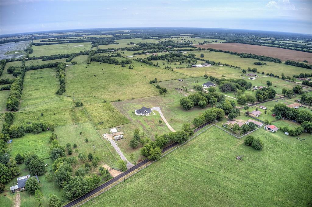 868 County Road 23940 Brookston, TX 75421 - Photo 10 of 29 a view of a swimming pool with a yard