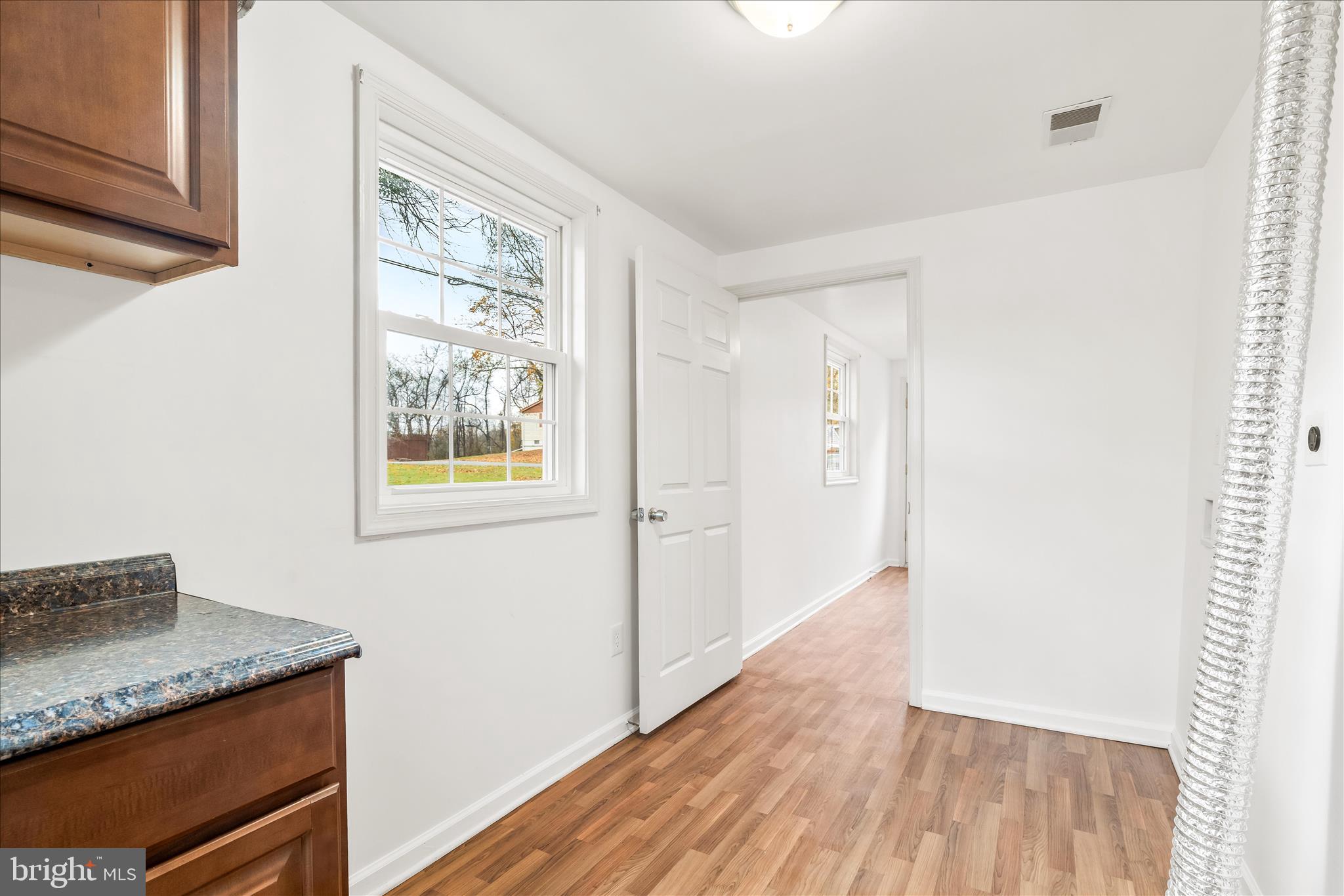 2060 Flag Marsh Road Mount Airy, MD 21771 - Photo 12 of 21 a hallway with front door wooden floor and window