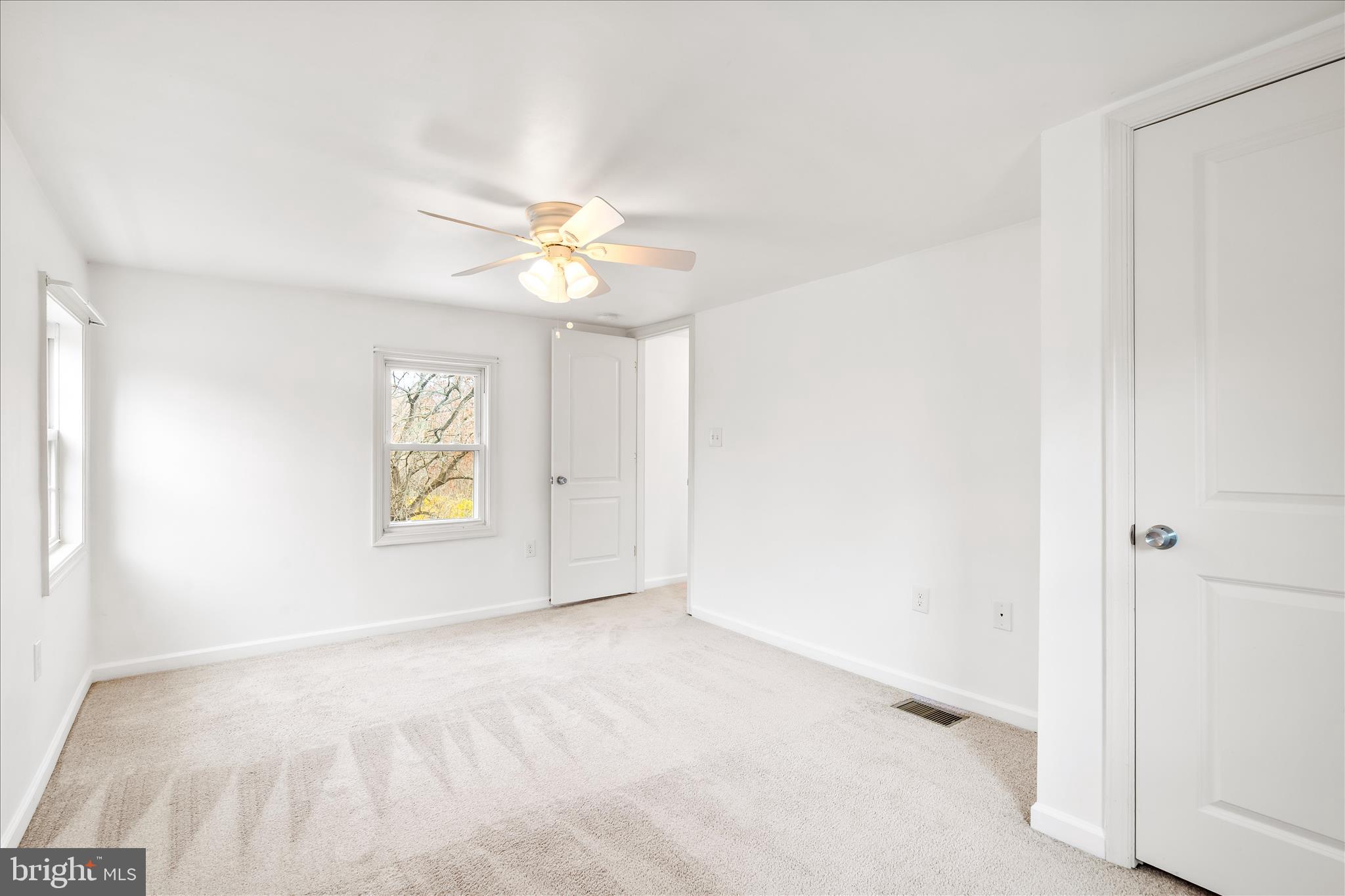 2060 Flag Marsh Road Mount Airy, MD 21771 - Photo 16 of 21 an empty room with windows and chandelier fan