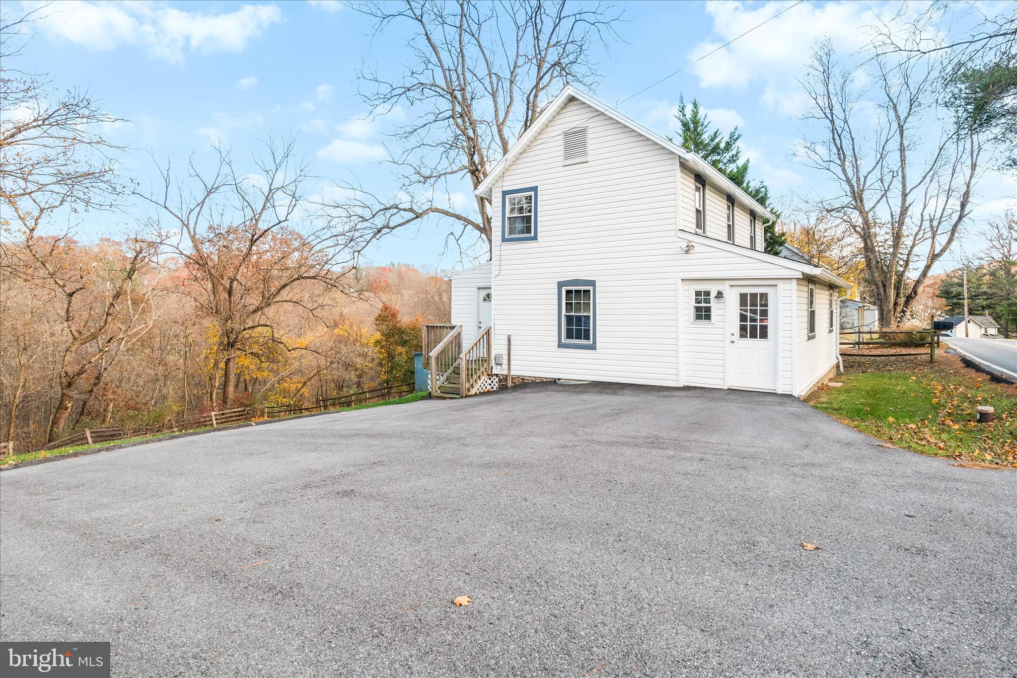 2060 Flag Marsh Road Mount Airy, MD 21771 - Photo 2 of 21 a view of a white house with a yard and garage