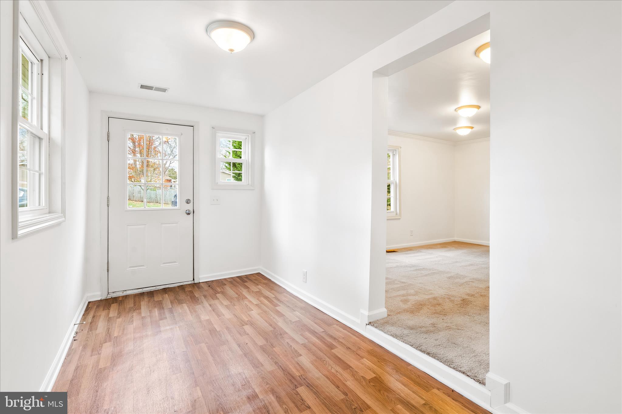 2060 Flag Marsh Road Mount Airy, MD 21771 - Photo 4 of 21 an empty room with wooden floor and windows
