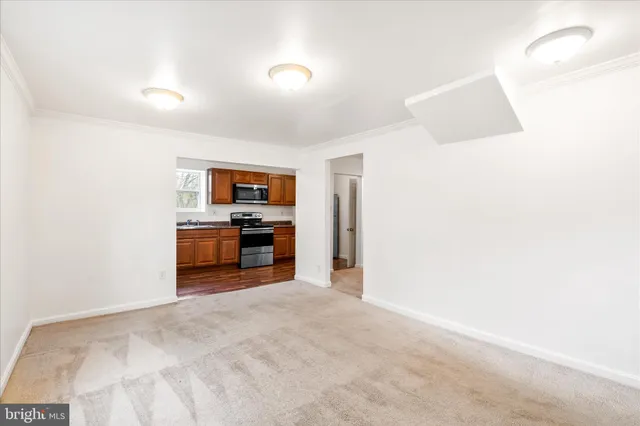 a kitchen with stainless steel appliances granite countertop a stove a sink dishwasher a refrigerator and a microwave oven