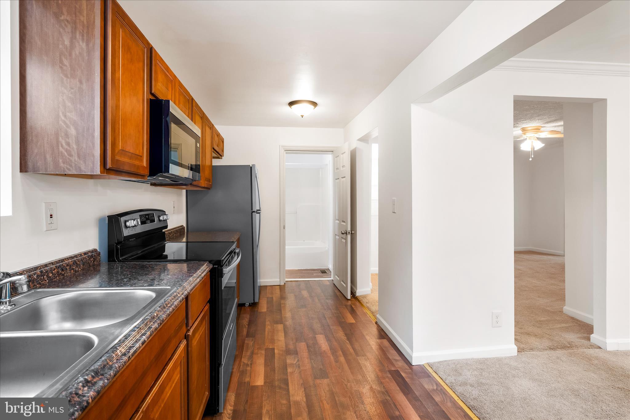 2060 Flag Marsh Road Mount Airy, MD 21771 - Photo 8 of 21 a kitchen with stainless steel appliances granite countertop a sink a stove and a refrigerator