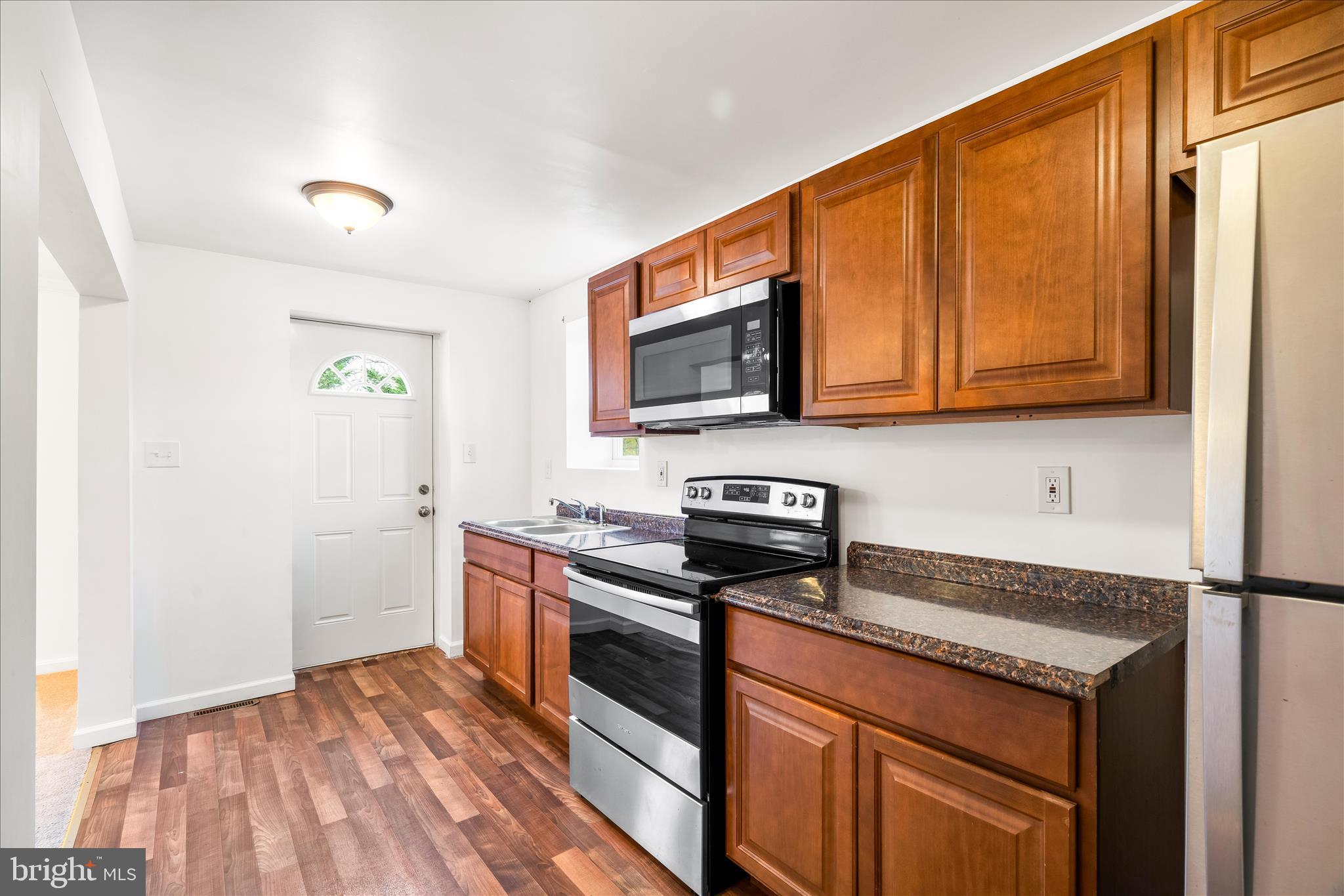 2060 Flag Marsh Road Mount Airy, MD 21771 - Photo 9 of 21 a kitchen with stainless steel appliances granite countertop a stove a sink and a microwave