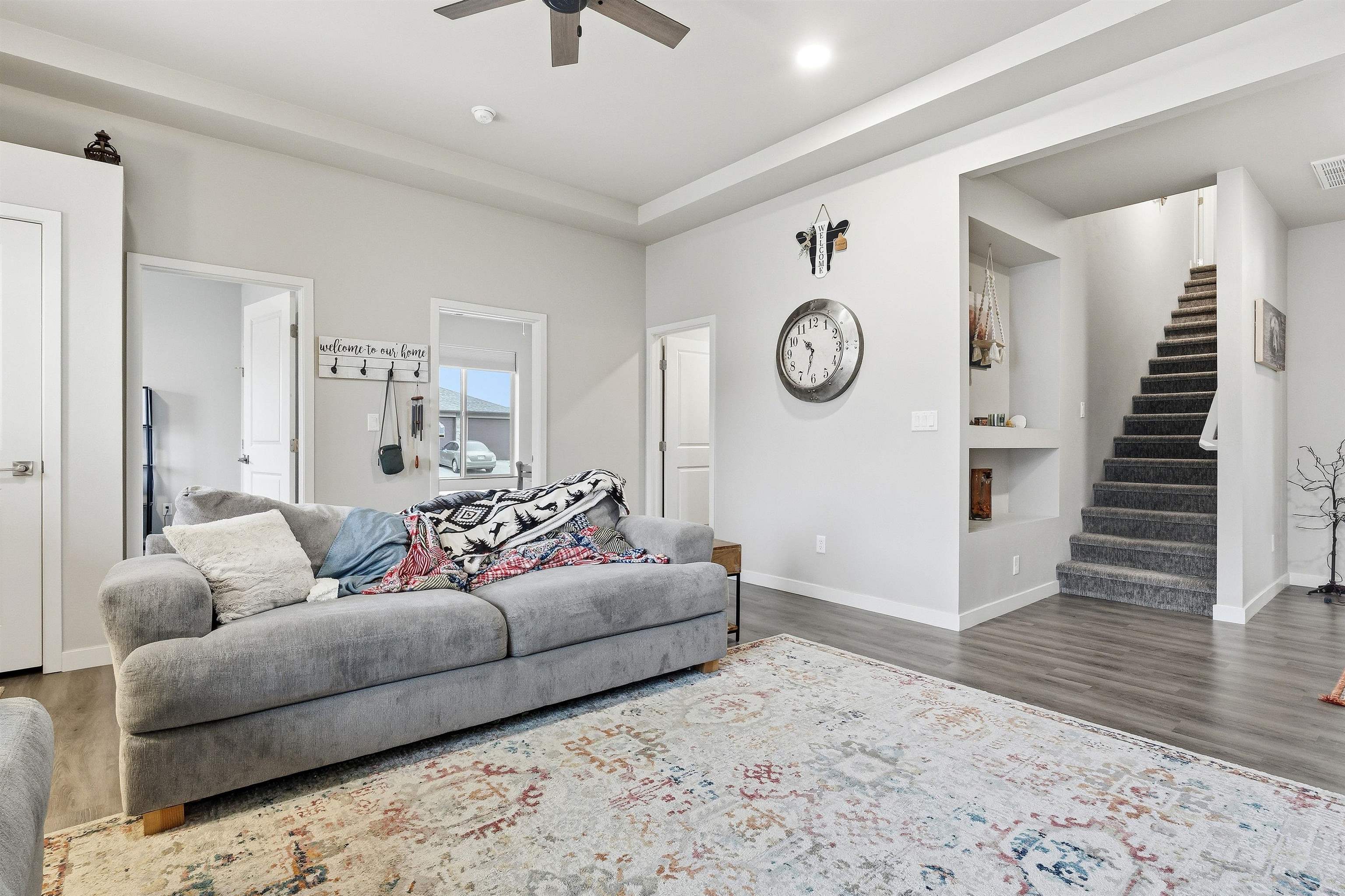 623 Thunder Ridge Drive Grand Junction, CO 81504 - Photo 11 of 40 a living room with furniture and a clock