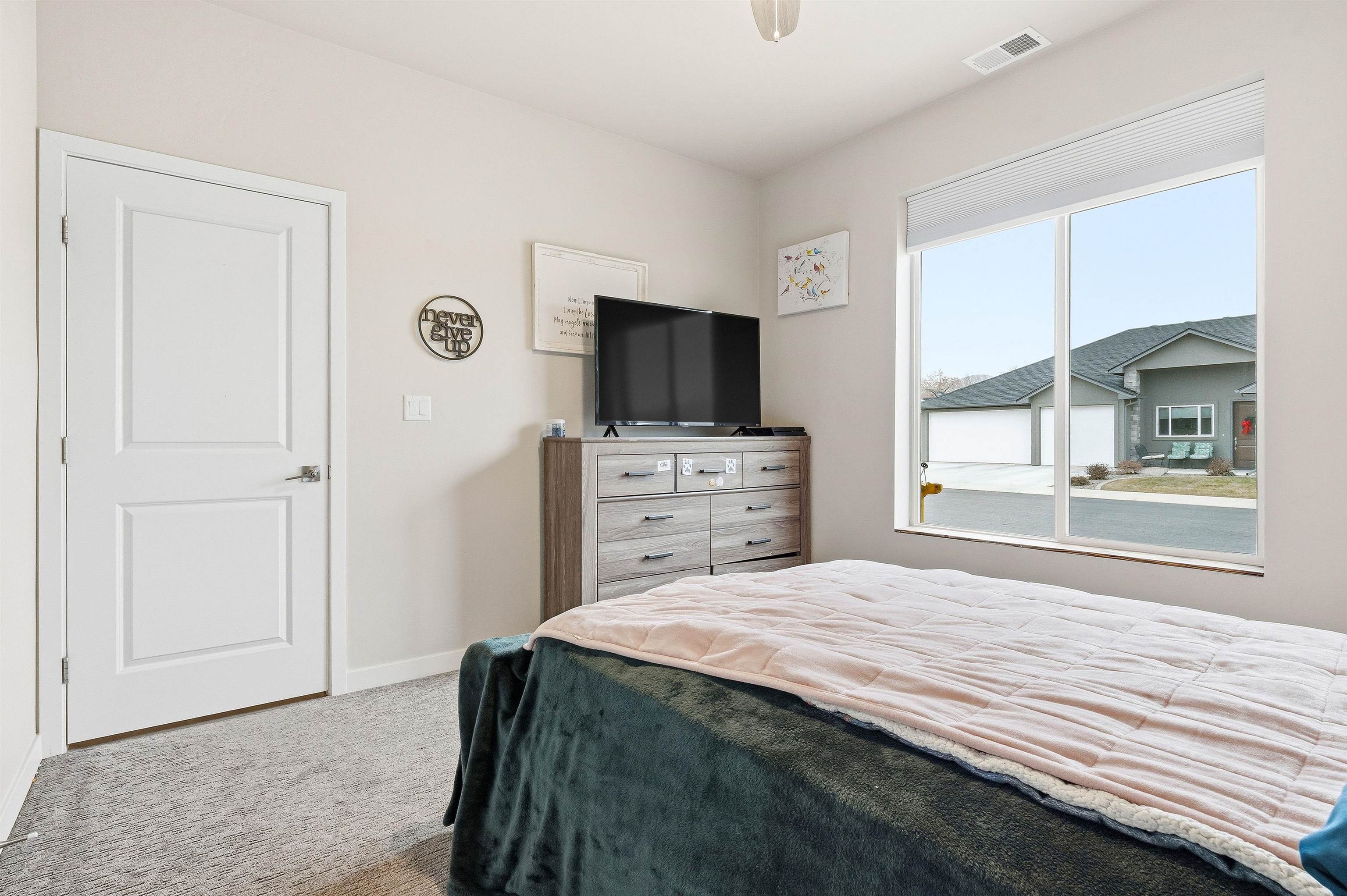 623 Thunder Ridge Drive Grand Junction, CO 81504 - Photo 12 of 40 a bedroom with a bed and a television