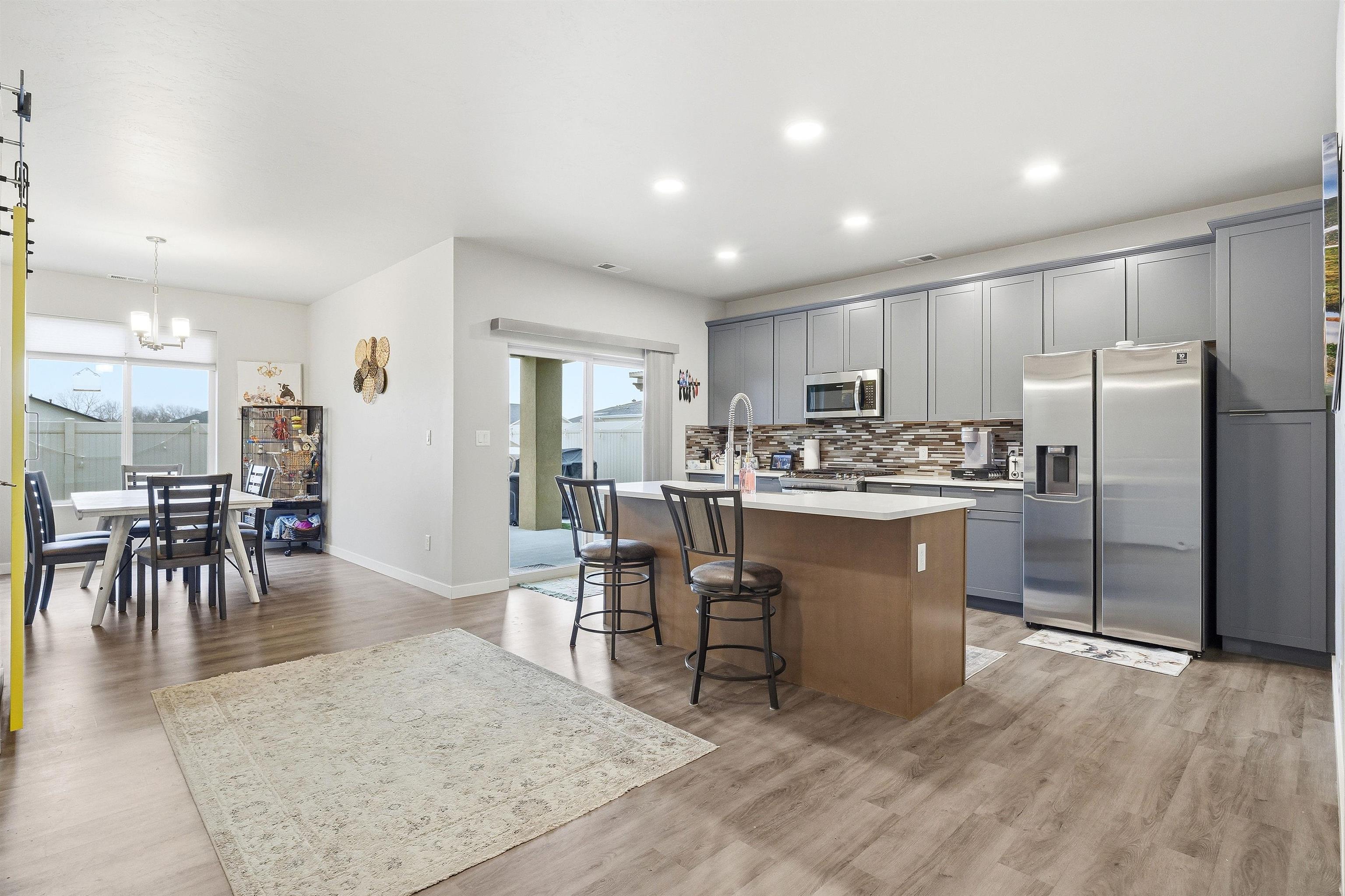 623 Thunder Ridge Drive Grand Junction, CO 81504 - Photo 18 of 40 a kitchen with a refrigerator a dining table and chairs