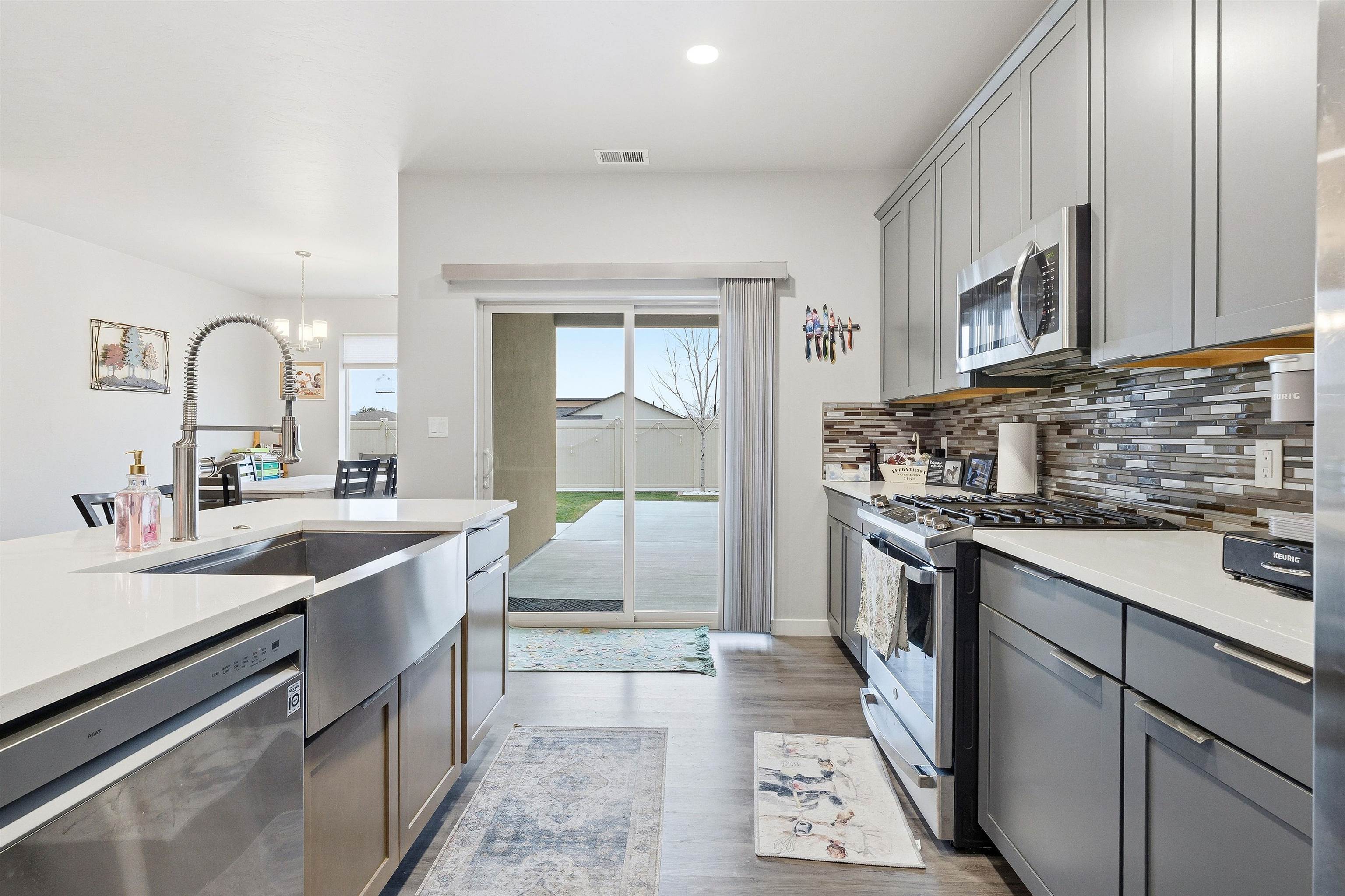 623 Thunder Ridge Drive Grand Junction, CO 81504 - Photo 20 of 40 a kitchen with stainless steel appliances granite countertop a sink stove refrigerator and cabinets