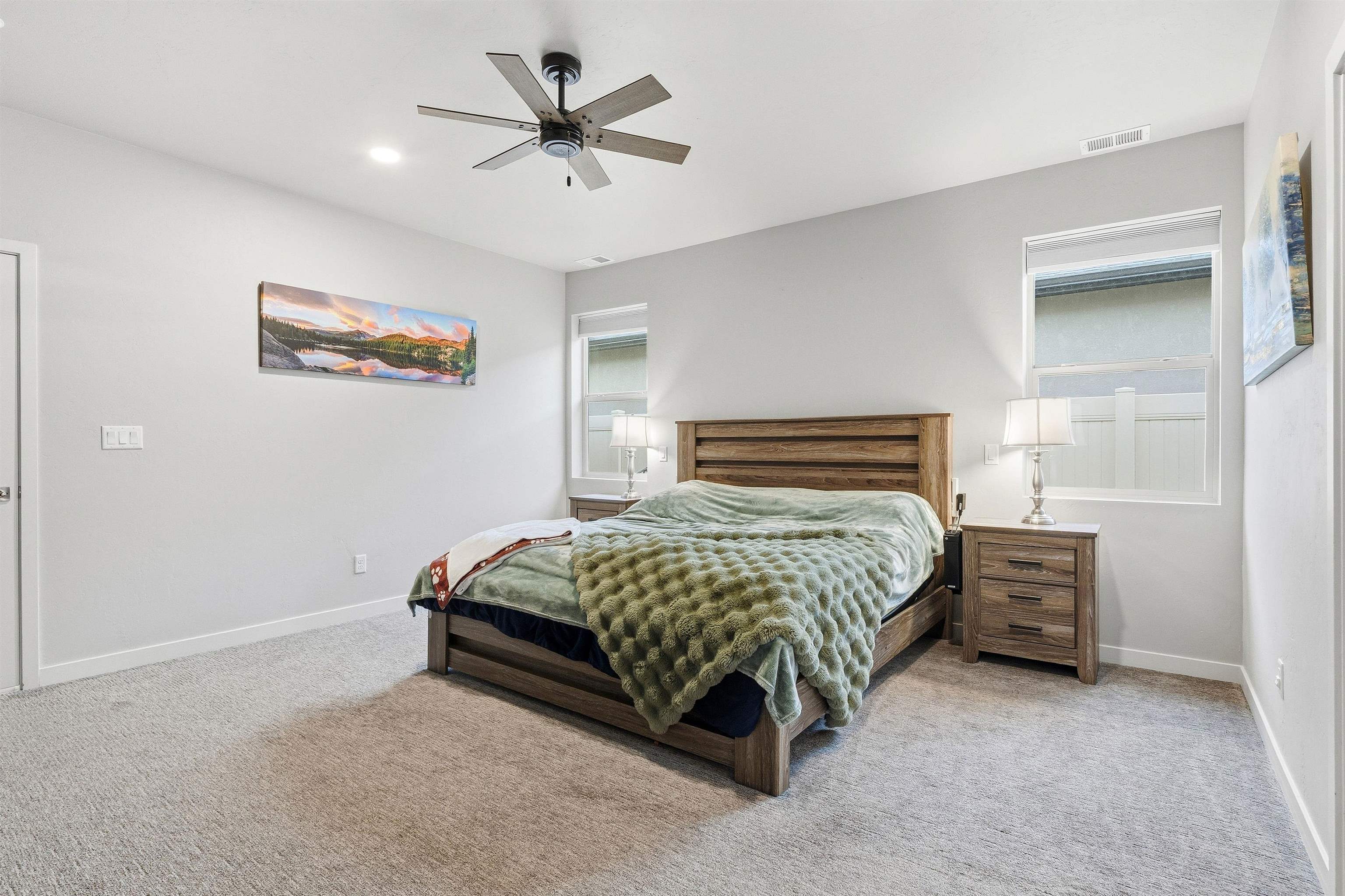 623 Thunder Ridge Drive Grand Junction, CO 81504 - Photo 29 of 40 a bedroom with a bed and a chandelier