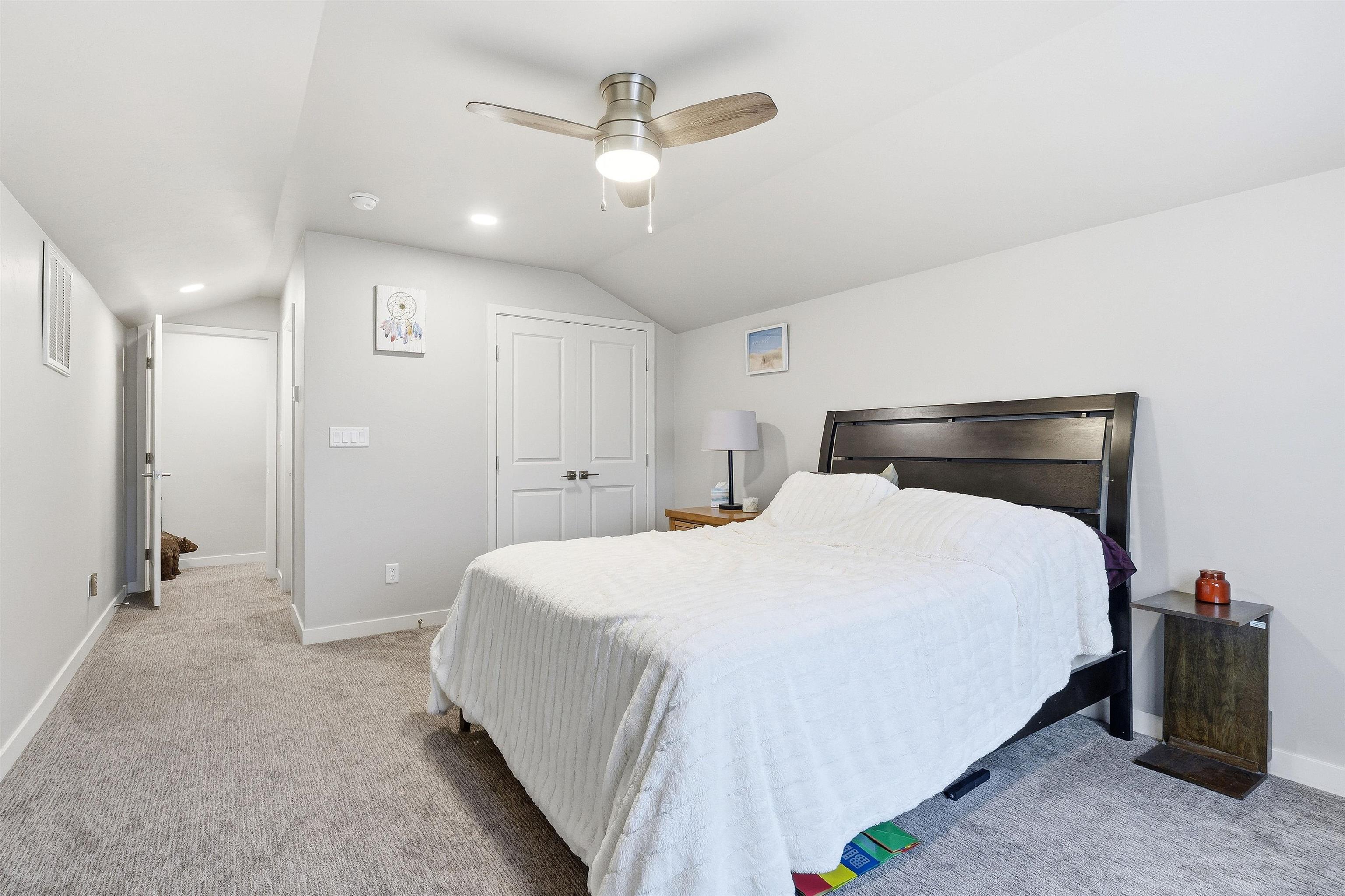 623 Thunder Ridge Drive Grand Junction, CO 81504 - Photo 34 of 40 a bedroom with a bed and a chandelier